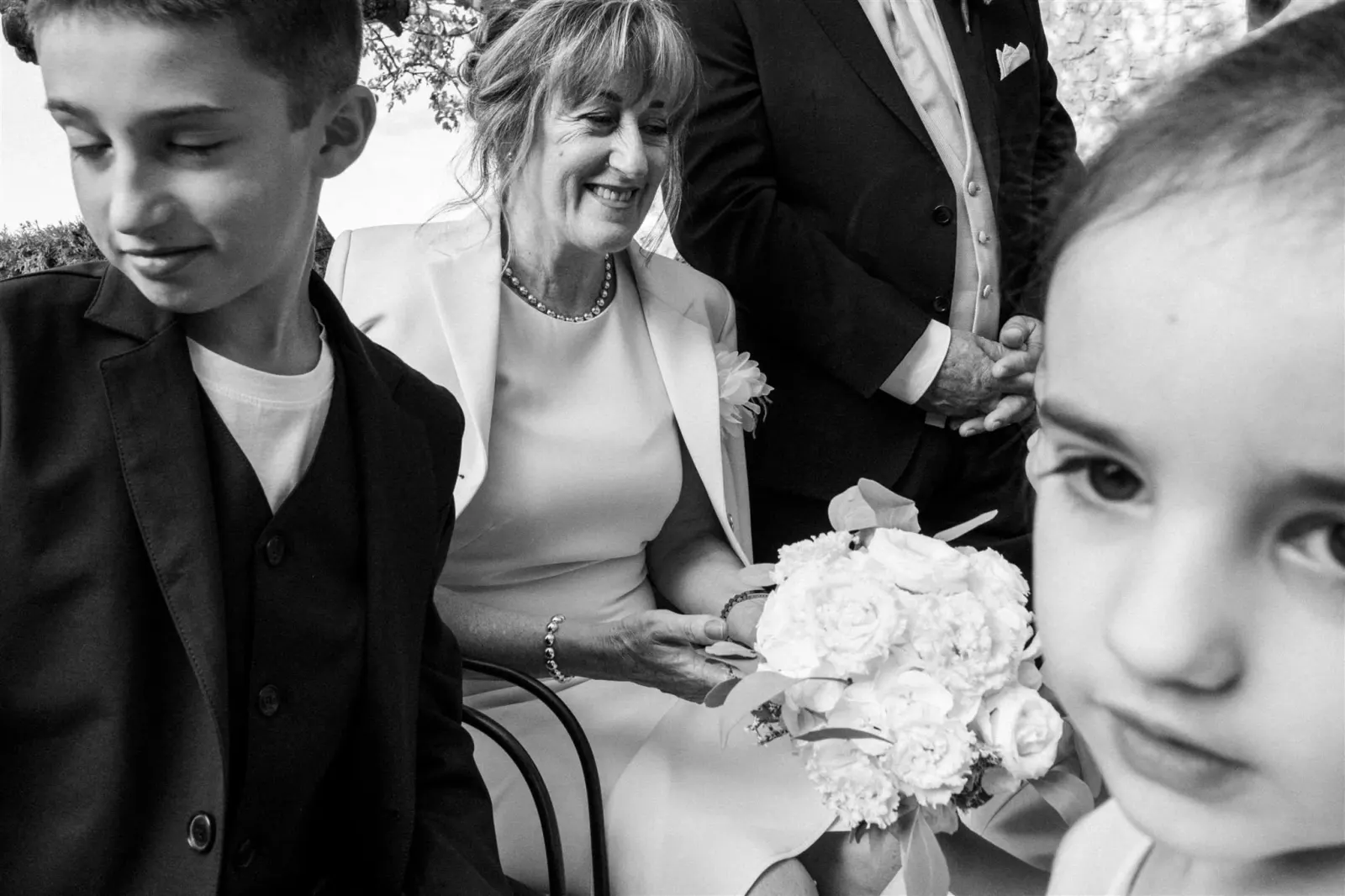 A boy, a bride and a small girl side by side, in black and white